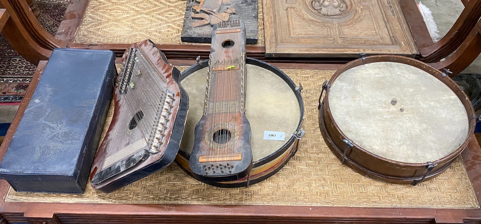 A group of assorted musical instruments comprising two large tambourines, two zithers and a Zenith trumpet